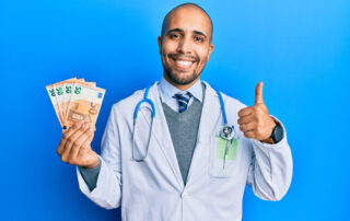 Doctor holding money and giving a thumbs up